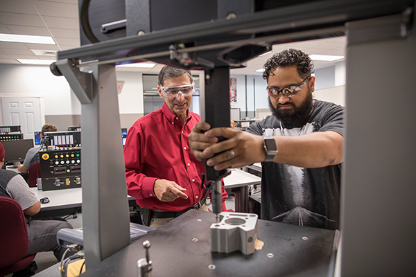 Professor working with students in lab