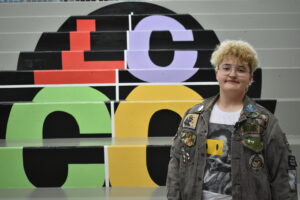 Image shows Kas Brittenburg in front of the Student Union steps with the LCCC logo painted on the steps.