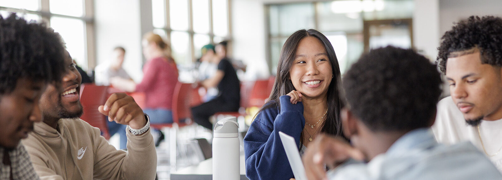 Male and female students talking and smiling