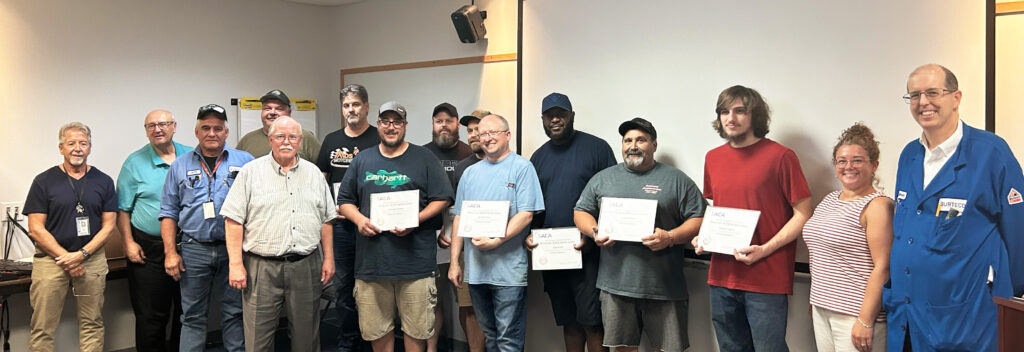 Image shows Omnova employees holding certificates of completion.