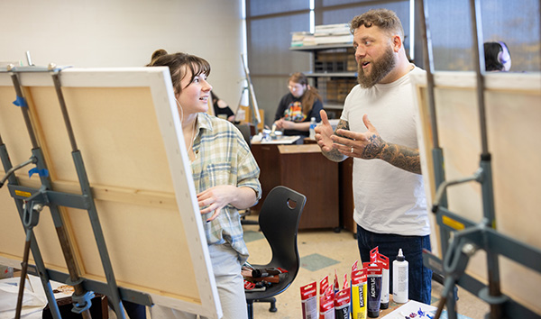 Teacher and student working in art studio